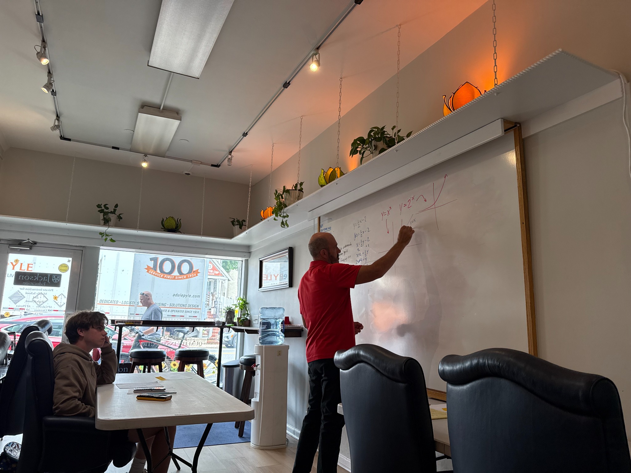 An instructor teaching SAT and ACT mathematics in the Jackson Education classroom